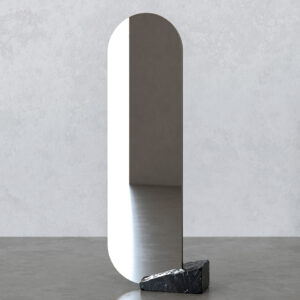 Tall rounded-rectangle ECO mirror set into a dark veined reclaimed marble block, photographed on a concrete floor against a light textured wall.