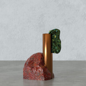 Close-up of the Forma vase showing a brushed brass cylinder beside an irregular dark-veined marble element, highlighting material textures and fine surface scratches.