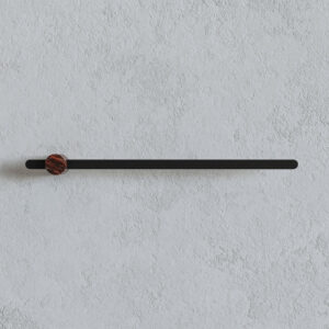 Wall-mounted Gesti towel bar: slim matte-black metal rod with a round red-veined marble end cap on a light textured wall.